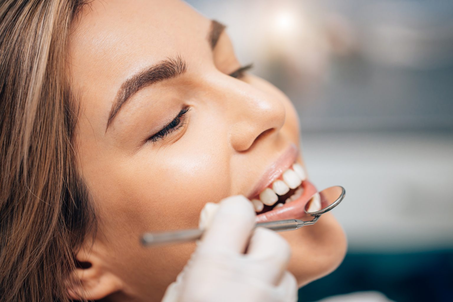 beautiful caucasian woman visiting dentist, doctor doing dental examination before treatment, ideal teeth